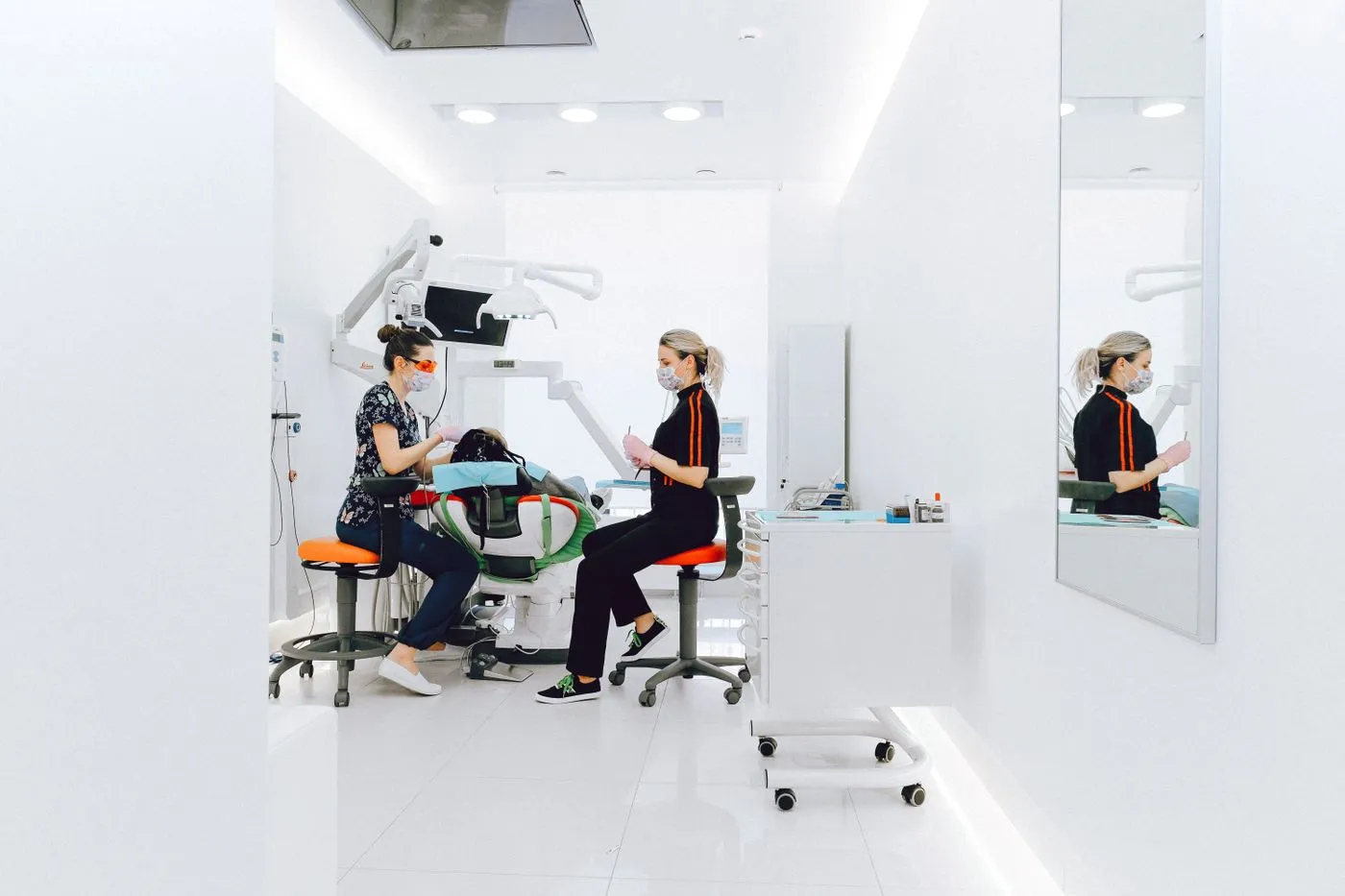 Dentist speaking with a relaxed patient in a bright treatment room
