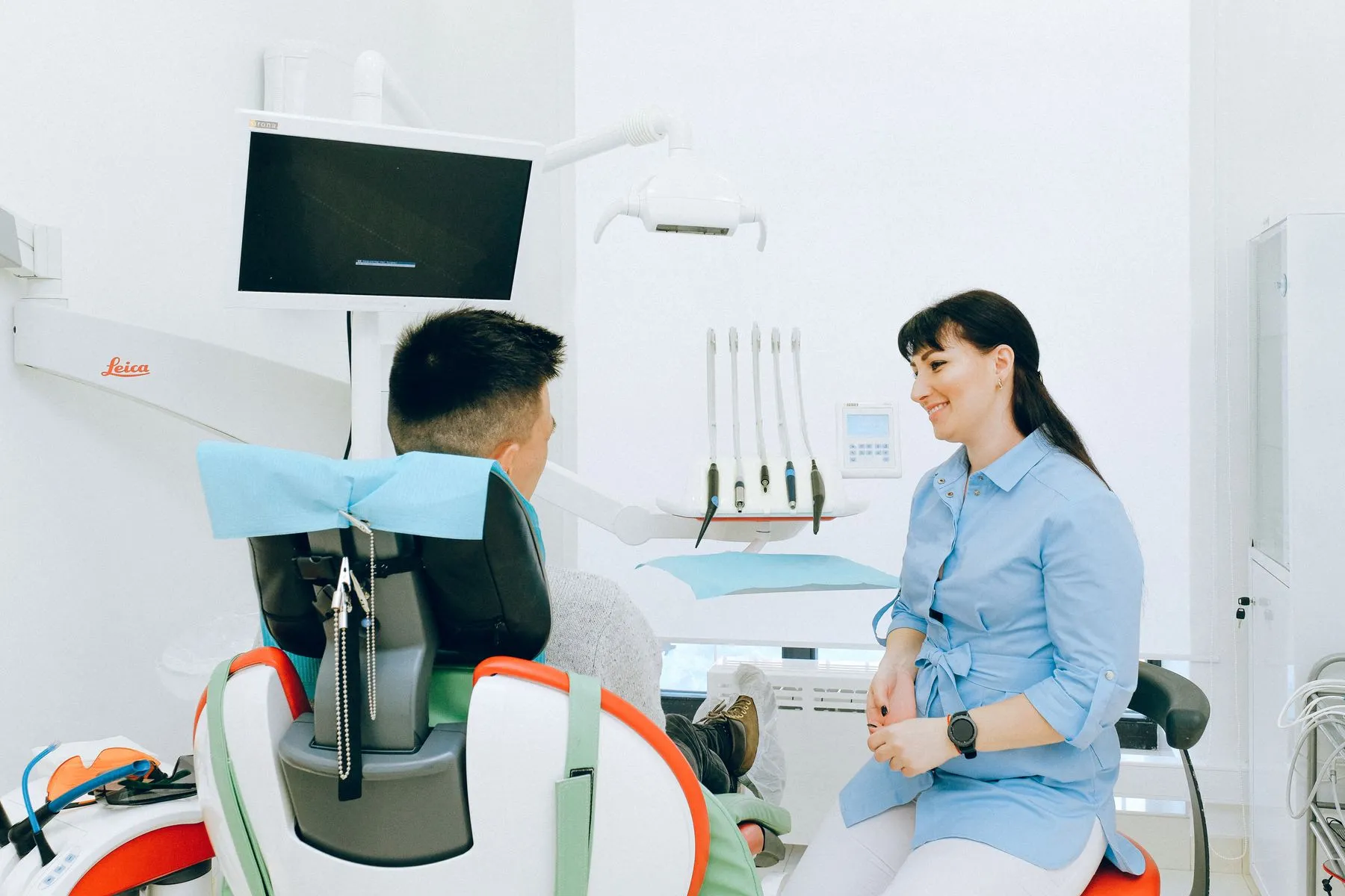 Dentist listening to a patient in a calm treatment room