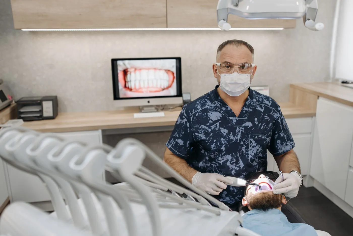 Two dental team members smiling in the practice